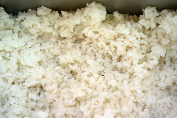 Boiled rice in a container close-up. Rice texture.