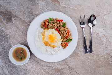 rice topped with stir-fried mince pork and basil with fried egg , Thai famous Street food