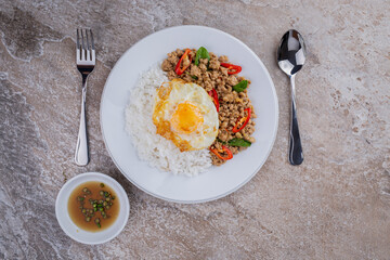 rice topped with stir-fried mince pork and basil with fried egg , Thai famous Street food