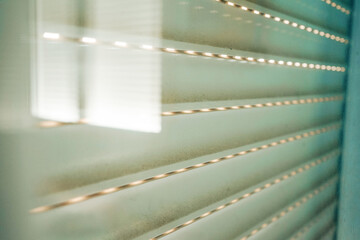Image of an old and dirty blind and the sunligth