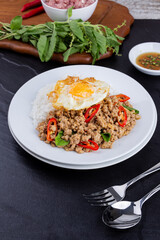 rice topped with stir-fried mince pork and basil with fried egg , Thai famous Street food