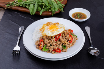 rice topped with stir-fried mince pork and basil with fried egg , Thai famous Street food