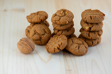 Very tasty peanut butter biscuits on bamboo light brown wooden board, golden baked healthy