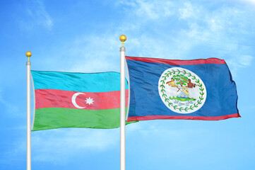 Azerbaijan and Belize two flags on flagpoles and blue sky