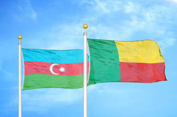 Azerbaijan and Benin two flags on flagpoles and blue sky