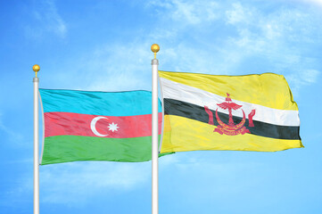 Azerbaijan and Brunei two flags on flagpoles and blue sky