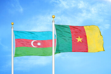 Azerbaijan and Cameroon two flags on flagpoles and blue sky