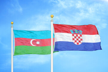 Azerbaijan and Croatia two flags on flagpoles and blue sky