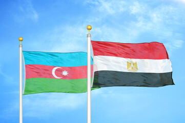 Azerbaijan and Egypt two flags on flagpoles and blue sky