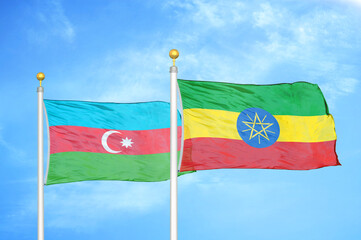 Azerbaijan and Ethiopia two flags on flagpoles and blue sky