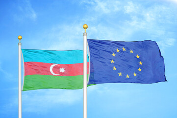 Azerbaijan and European Union two flags on flagpoles and blue sky