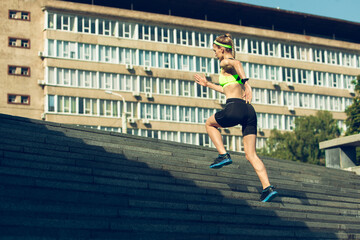 Upstairs. Female runner, athlete training outdoors. Professional runner, jogger working out on the...