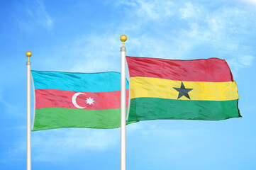 Azerbaijan and Ghana two flags on flagpoles and blue sky