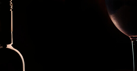 Chilled dry red wine in the glass. Dark vintage wood background. Panoramic banner with copy space