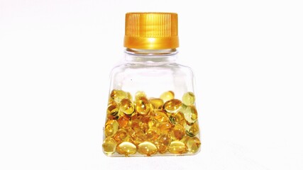 Cod liver oil  or fish oil gel capsules jar  on white background. It contains omega 3 fatty acids , EPA,  DHA