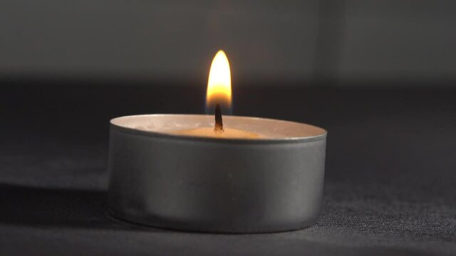 Blowing off a tealight, slow motion