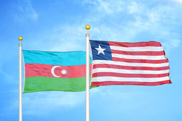 Azerbaijan and Liberia two flags on flagpoles and blue sky