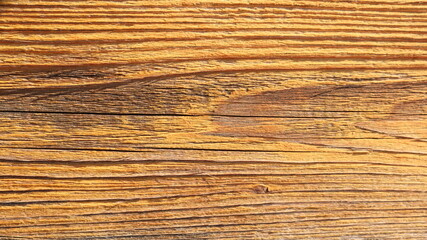 fragment of wooden rustic country style background with empty texture surface of bright orange-brown color and relief of pronounced lines of wood texture