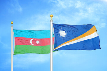 Azerbaijan and Marshall Islands two flags on flagpoles and blue sky