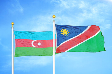 Azerbaijan and Namibia two flags on flagpoles and blue sky