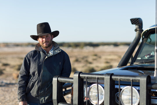 Young bloke in outback near vehicle with bullbar