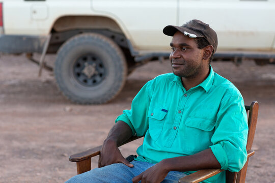 Young indigenous man relaxing in chair outdoors