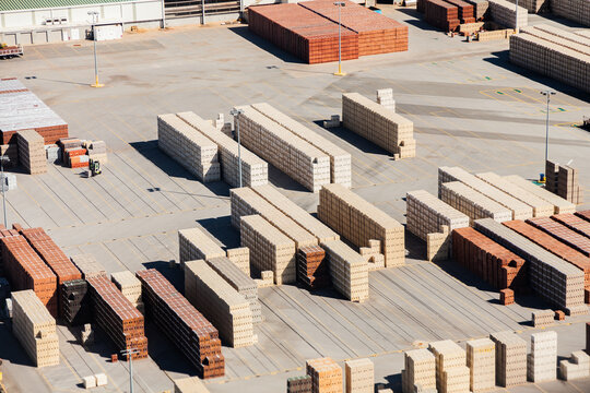 Piles of bricks in store area in industrial area of city