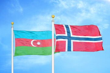 Azerbaijan and Norway two flags on flagpoles and blue sky