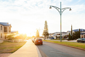 Cars parked on the street at sunset - coastal community