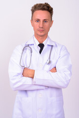 Handsome man doctor with blond curly hair against white background