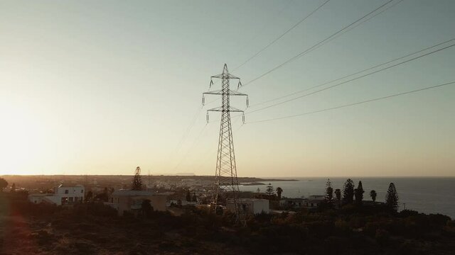 Electric voltage pole in the beautiful village during sunset.