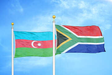 Azerbaijan and South Africa two flags on flagpoles and blue sky