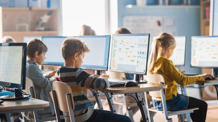 Elementary School Computer Science Classroom: Smart Little Schoolchildren Work on Personal...