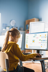 Elementary School Computer Science Classroom: Cute Little Girl Uses Computer, Learning Programming...