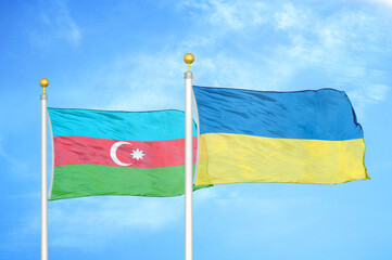 Azerbaijan and Ukraine two flags on flagpoles and blue sky