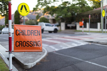 Children crossing sign on roadside at pedestrian crossing