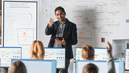 Elementary School Computer Science Class: Teacher Uses Digital Tablet, Explains Lesson to Diverse...