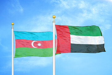 Azerbaijan and United Arab Emirates two flags on flagpoles and blue sky