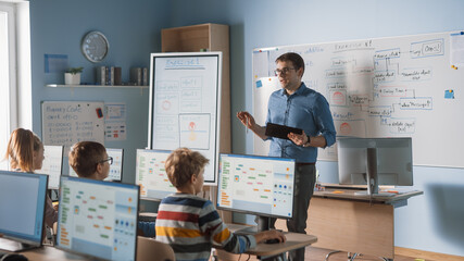 School Class: Portrait of the Enthusiastic and Motivated Teacher Using Digital Tablet Computer,...