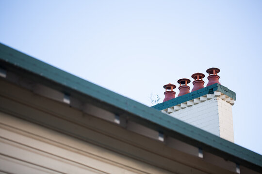 Four chimney vents on a roof