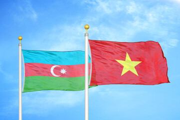 Azerbaijan and Vietnam two flags on flagpoles and blue sky