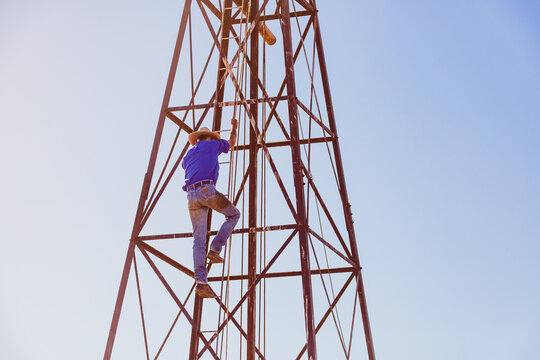 Man climbing windmill tower