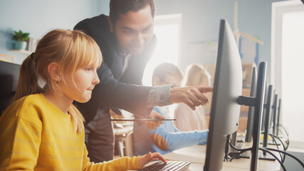 Elementary School Science Classroom: Teacher Explains to a Smart Little Schoolgirl how to use...