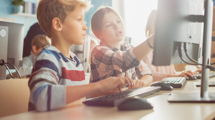 Elementary School Computer Science Classroom: Portrait of Smart Girl, Boy Working Together and...