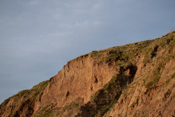 Fototapeta na wymiar Beach cliffs with blue sky