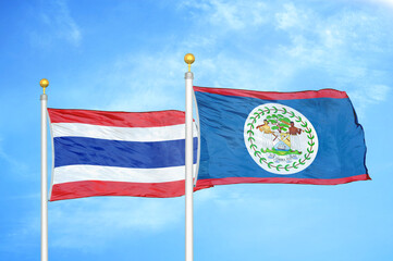 Thailand and Belize two flags on flagpoles and blue sky