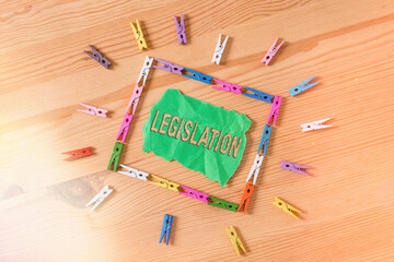 Conceptual hand writing showing Legislation. Concept meaning the exercise of the power and function of making rules Colored crumpled papers wooden floor background clothespin - obrazy, fototapety, plakaty
