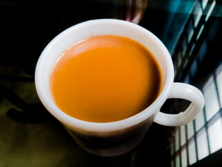 A Cup of milk tea placed in a table.