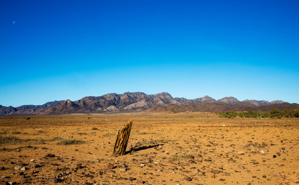 old fence post with mountains in background