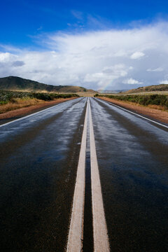 View down the double lines of a straight outback bitumen road